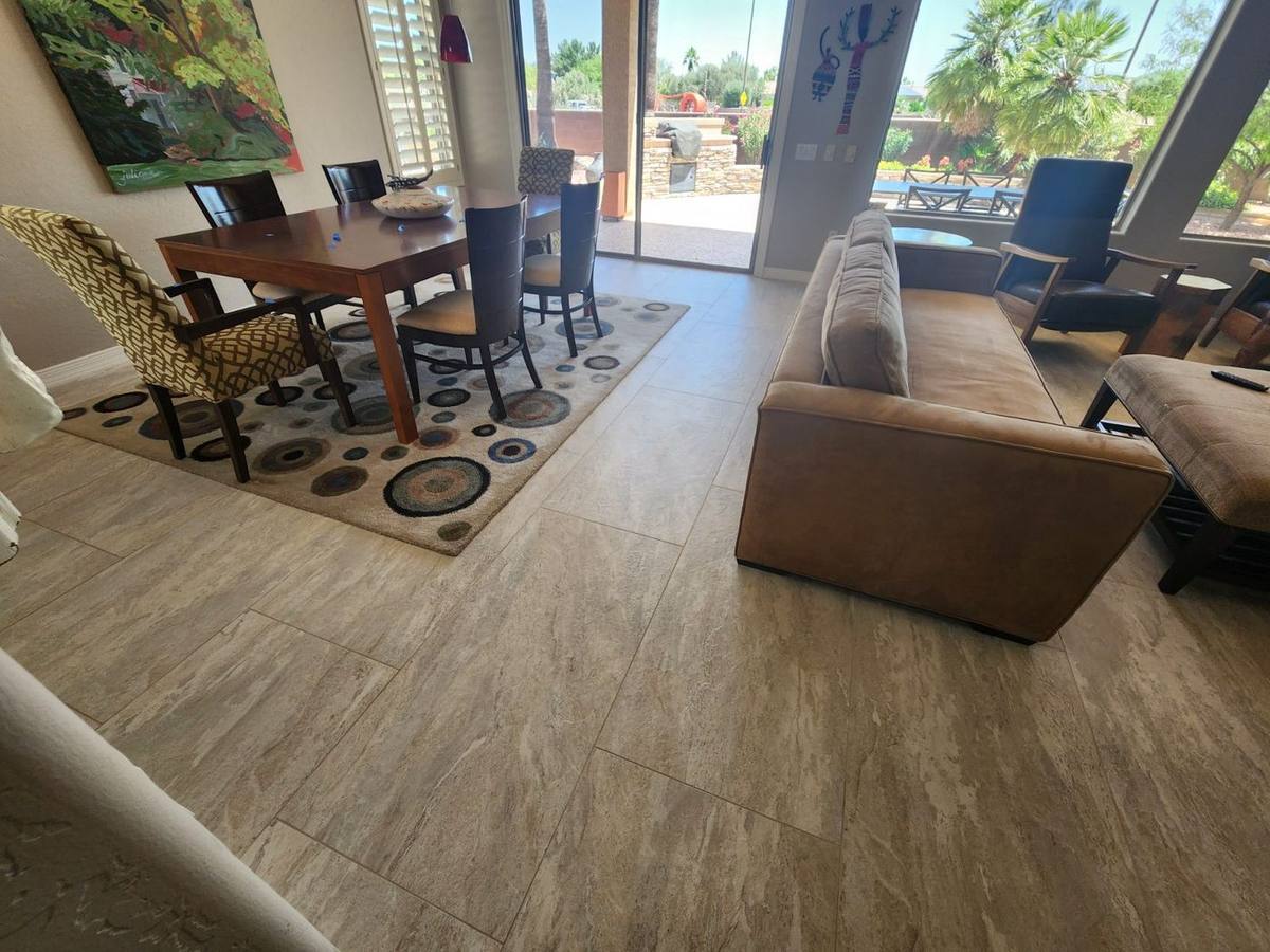 Large-format stone-look porcelain tile flooring throughout an open concept living space